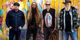 Atomic Rooster band members standing in front of colorful graffiti wall – live at The Cavern Club Liverpool, March 1st 2026