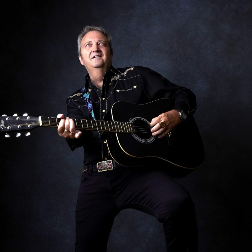 Billy Fury tribute artist performing live with acoustic guitar at the Cavern Club Liverpool