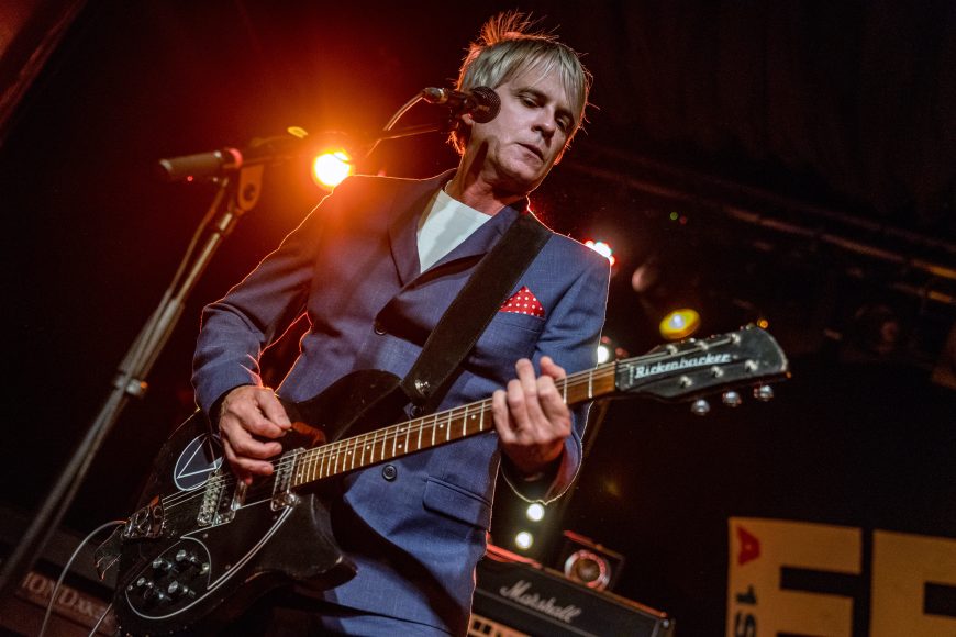Russell Hastings performing live on stage with a Rickenbacker guitar at The Cavern Club